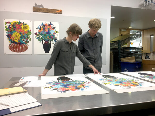 Tamarind Institute of Lithography Staff and Student looking at lithographs